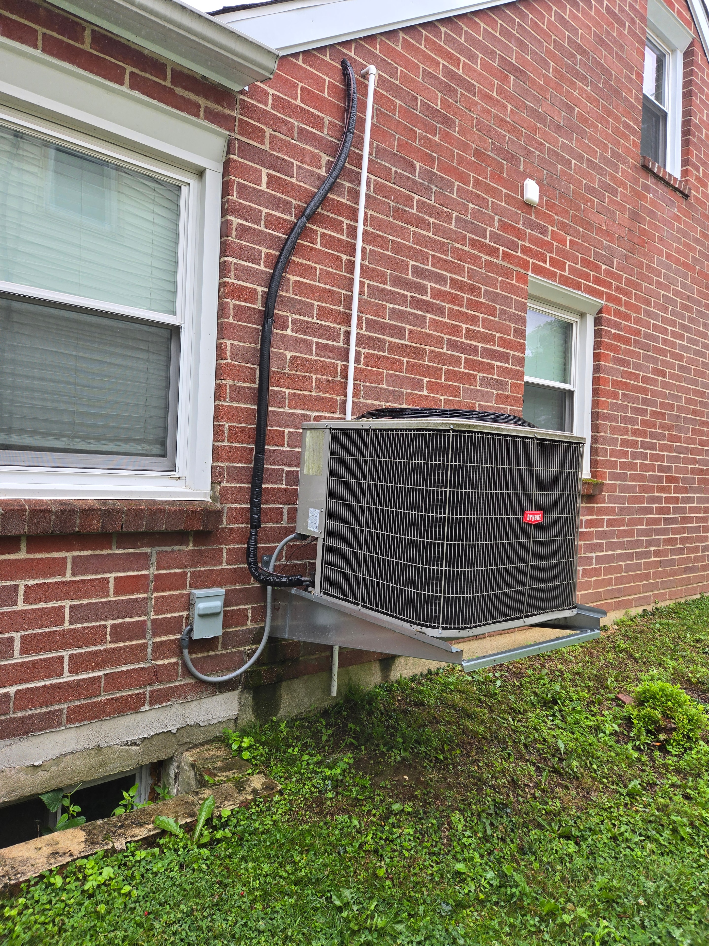 DMES LLC residential air conditioning condensing units installed on brick exterior